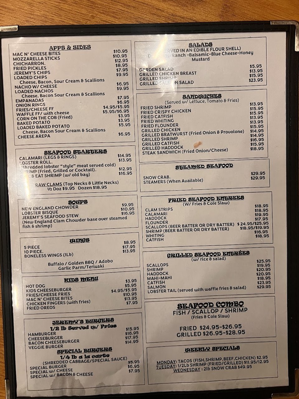 Printed menu beside fried appetizers and soups.